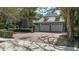 Charming home featuring a two-car garage with a brick driveway and manicured landscaping at 1774 Cherokee Dr, Sarasota, FL 34239