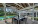 Beautiful gazebo with dining table, ceiling fan, and backyard pool view, perfect for outdoor entertaining at 1774 Cherokee Dr, Sarasota, FL 34239