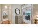 Hallway features hardwood flooring, neutral paint, and leads to various rooms in the home at 1774 Cherokee Dr, Sarasota, FL 34239