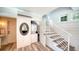 Well-lit laundry room featuring modern appliances, stylish decor, and access to the stairwell at 1774 Cherokee Dr, Sarasota, FL 34239