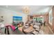 Spacious living room featuring modern furniture, stylish lighting, and hardwood floors at 1774 Cherokee Dr, Sarasota, FL 34239