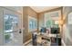 Bright home office with natural light, custom desk, and a view of the lush backyard at 1774 Cherokee Dr, Sarasota, FL 34239