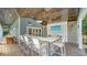 Covered outdoor bar with wood ceiling, stylish seating, and coastal décor at 1774 Cherokee Dr, Sarasota, FL 34239