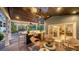 Cozy outdoor seating area with comfortable chairs and a view of the backyard pool and lush landscaping at 1774 Cherokee Dr, Sarasota, FL 34239
