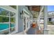 Covered outdoor patio with wooden floors, stylish lighting fixtures and outdoor games at 1774 Cherokee Dr, Sarasota, FL 34239