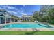 Picturesque pool area with lush landscaping and outdoor entertainment spaces at 1774 Cherokee Dr, Sarasota, FL 34239