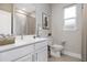 Bright bathroom with white vanity, stone countertops, large mirror and decor at 18100 Poston Ave, Port Charlotte, FL 33948