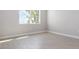 Bright bedroom featuring tile floors, large window, and neutral paint at 18100 Poston Ave, Port Charlotte, FL 33948