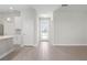 Bright hallway with tile floors, leading to the front door, and views of the adjacent rooms at 18100 Poston Ave, Port Charlotte, FL 33948