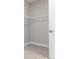 Empty walk-in closet featuring wire shelving and tile flooring at 18100 Poston Ave, Port Charlotte, FL 33948