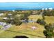 Aerial view of a home with a covered pool on a large grassy lot with a red shed and white fencing at 2005 21St W St, Palmetto, FL 34221