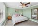 Calming bedroom with a ceiling fan and a large window overlooking the yard at 2005 21St W St, Palmetto, FL 34221