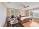 Inviting bedroom with hardwood floors, a cozy seating area, and a ceiling fan, creating a comfortable and relaxing atmosphere at 2005 21St W St, Palmetto, FL 34221
