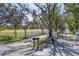 Tree-lined driveway leading to the house with a white fence and open green space at 2005 21St W St, Palmetto, FL 34221