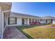 Quaint single-story home with a covered porch, black shutters, and a brick walkway leading to the entrance at 2005 21St W St, Palmetto, FL 34221