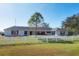 White brick home surrounded by a white fence and a well maintained lawn and landscaping at 2005 21St W St, Palmetto, FL 34221