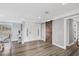 Bright foyer boasts wood floors, white trim, and a sliding barn door to a secondary room at 2005 21St W St, Palmetto, FL 34221