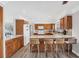 Open concept kitchen with wood cabinets, granite countertops, an island, and breakfast bar seating at 2005 21St W St, Palmetto, FL 34221