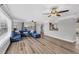 Living room featuring recessed lighting, ceiling fans, wood floors, and comfortable blue seating at 2005 21St W St, Palmetto, FL 34221