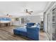 Open concept living room with patio access, a ceiling fan, and comfortable blue seating at 2005 21St W St, Palmetto, FL 34221