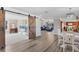 View of the open concept living room through a rustic sliding barn door at 2005 21St W St, Palmetto, FL 34221