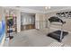 Spacious living area featuring neutral carpet, front door view, and workout equipment, perfect for a multi-functional space at 2005 21St W St, Palmetto, FL 34221
