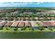 Stunning aerial view of a neighborhood along a waterfront, showcasing well-maintained homes at 204 Maraviya Blvd, Nokomis, FL 34275