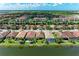 Beautiful aerial view of a residential home and community with lake and lush landscaping at 204 Maraviya Blvd, Nokomis, FL 34275