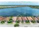Aerial view of waterfront homes featuring barrel tile roofs in a vibrant lakeside community at 204 Maraviya Blvd, Nokomis, FL 34275