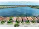Aerial view of waterfront homes featuring barrel tile roofs in a vibrant lakeside community at 204 Maraviya Blvd, Nokomis, FL 34275
