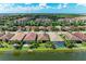 Stunning aerial view of waterfront homes with screened lanais and lush tropical landscaping at 204 Maraviya Blvd, Nokomis, FL 34275