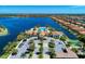 Expansive aerial view showcases community clubhouse, pool, and lakefront property at 204 Maraviya Blvd, Nokomis, FL 34275
