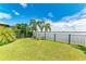 Serene backyard with palm trees, manicured lawn, and peaceful water views, a true tropical retreat at 204 Maraviya Blvd, Nokomis, FL 34275