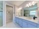 Bathroom featuring double vanity, quartz counters, updated cabinets, and a walk-in shower at 204 Maraviya Blvd, Nokomis, FL 34275