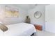 Comfortable bedroom with a bed, dresser, and a decorative mirror at 204 Maraviya Blvd, Nokomis, FL 34275