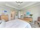 Bright bedroom with trey ceilings, a ceiling fan, and neutral colors throughout the space at 204 Maraviya Blvd, Nokomis, FL 34275