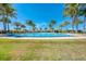Expansive community pool with lounge area surrounded by manicured landscaping, offering a relaxing outdoor experience at 204 Maraviya Blvd, Nokomis, FL 34275