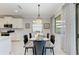 Well-appointed dining room with modern lighting, a stylish table setting, and neutral decor at 204 Maraviya Blvd, Nokomis, FL 34275
