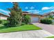 Charming single-Gathering home with a two-car garage, brick driveway, and lush landscaping at 204 Maraviya Blvd, Nokomis, FL 34275