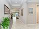 Open-concept foyer with tiled floors leading to the living area with views of the outdoor water at 204 Maraviya Blvd, Nokomis, FL 34275