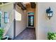 Close-up of a home's entrance with a decorative glass door and exterior light fixture at 204 Maraviya Blvd, Nokomis, FL 34275