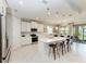 Bright open kitchen with large island, stainless appliances, white cabinetry, and access to the dining room at 204 Maraviya Blvd, Nokomis, FL 34275