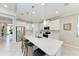 Spacious kitchen with stainless appliances, white cabinetry, quartz countertops, island with seating, and pendant lights at 204 Maraviya Blvd, Nokomis, FL 34275