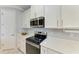 Modern kitchen features stainless steel appliances, quartz countertops, and white cabinetry with ample storage at 204 Maraviya Blvd, Nokomis, FL 34275