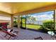 Screened lanai with brick pavers, lounge chairs, and views of the water and palm trees at 204 Maraviya Blvd, Nokomis, FL 34275