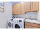 Convenient laundry room featuring modern Samsung washer and dryer units and ample cabinet space at 204 Maraviya Blvd, Nokomis, FL 34275