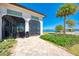 Screened outdoor patio with comfortable seating, overlooking a serene lake and lush landscaping at 204 Maraviya Blvd, Nokomis, FL 34275