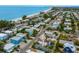 An aerial view captures a charming beachside community with homes close to the water at 2213 Avenue C, Bradenton Beach, FL 34217