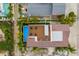 Aerial view of property highlighting pool, deck, and lush tropical surroundings at 2213 Avenue C, Bradenton Beach, FL 34217