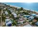 An aerial shot of a vibrant coastal community with beach access and clear blue water at 2213 Avenue C, Bradenton Beach, FL 34217